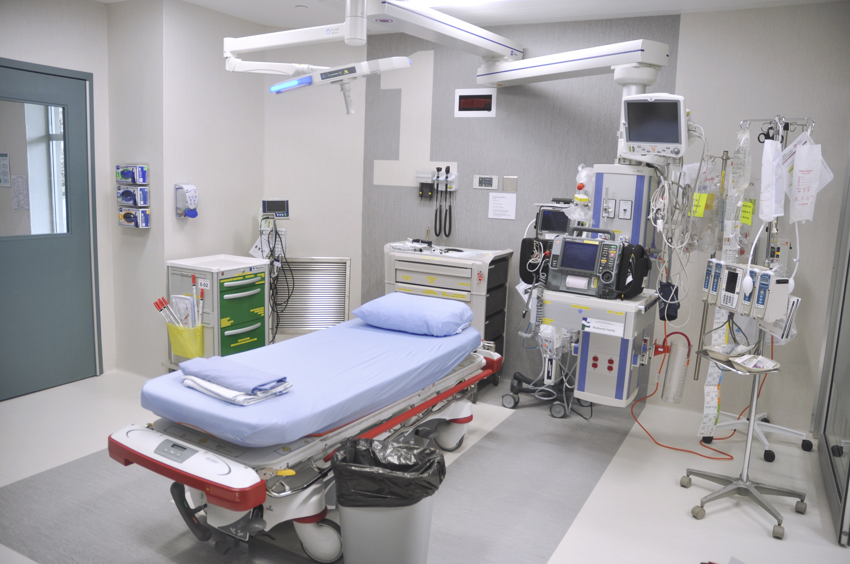 Interior of a trauma room showing equipment and a bed