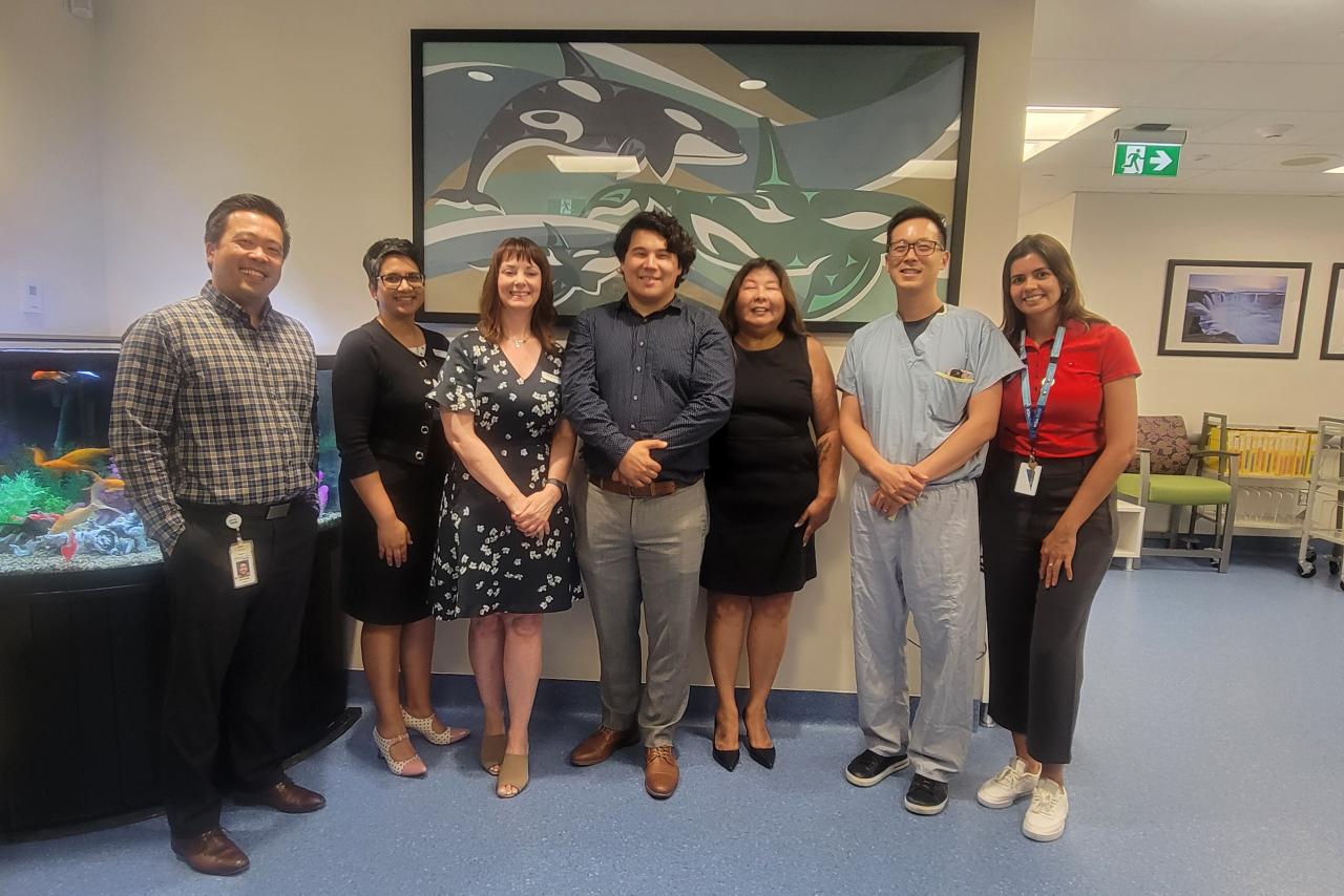 Unveiling group posing in front of the new Musqueam art piece in Cancer Care Clinic