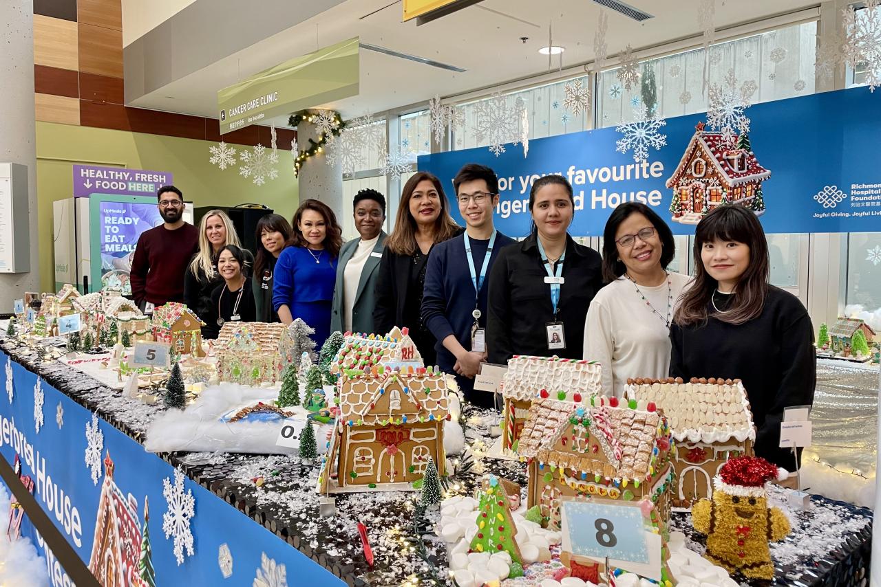 A group of participants in a Gingerbread House contest with their Houses