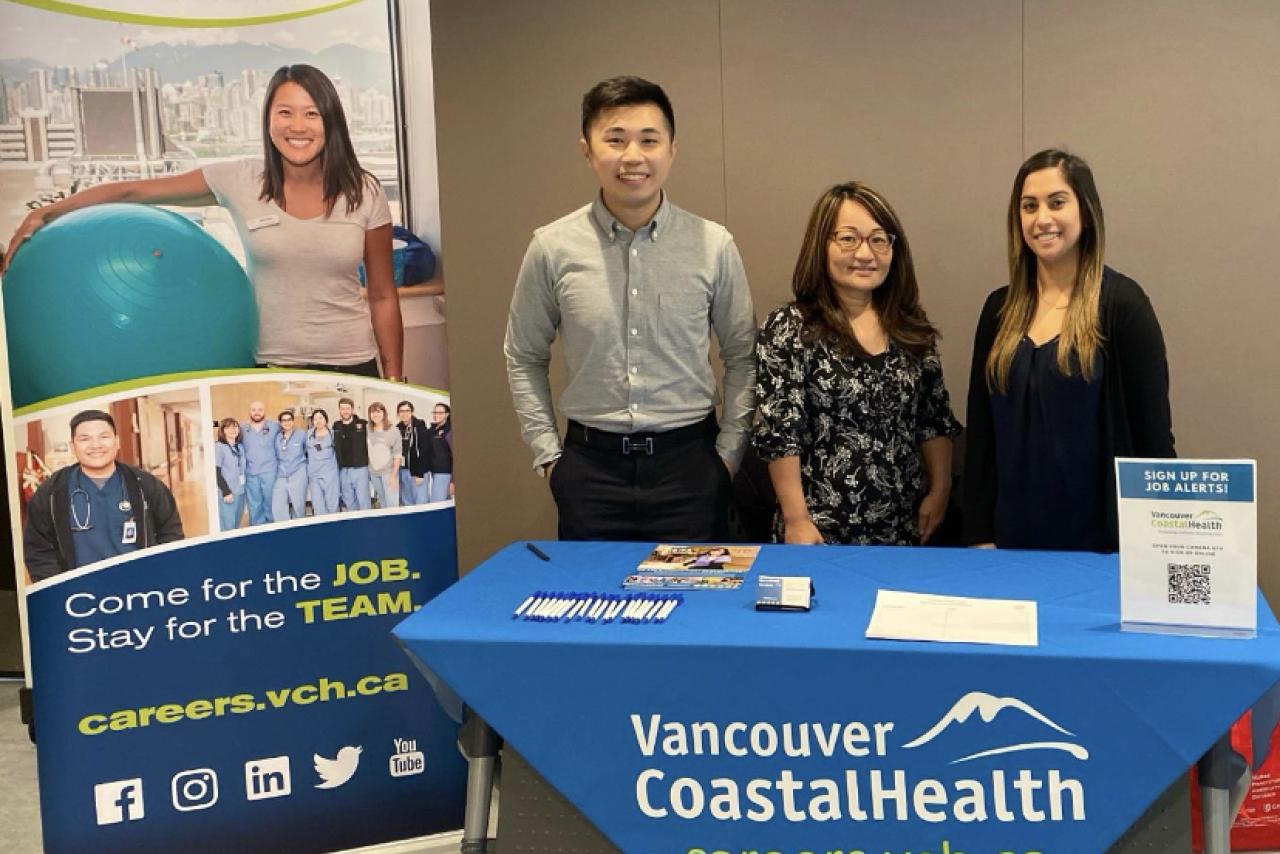 Talent Acquisition team standing behind VCH table