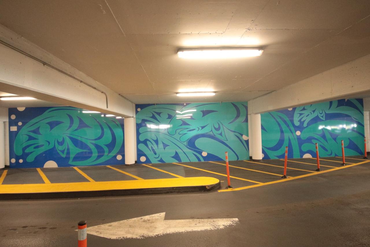 Large mural in parkade. This Coast Salish design, featuring a school of salmon, represents determination and the strong will to overcome obstacles with a true heart.