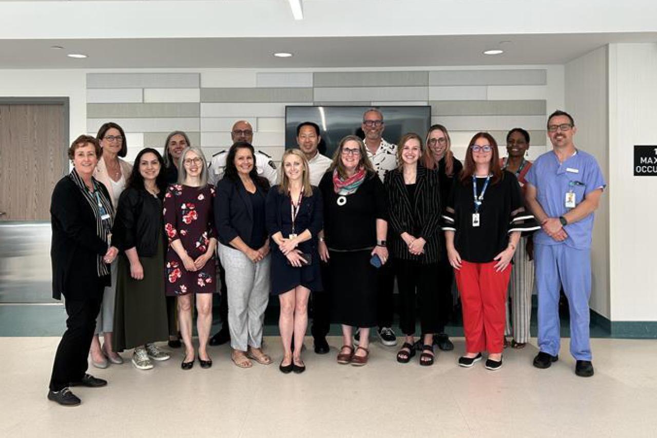 group photo of medical staff standing together in a hospital hallway