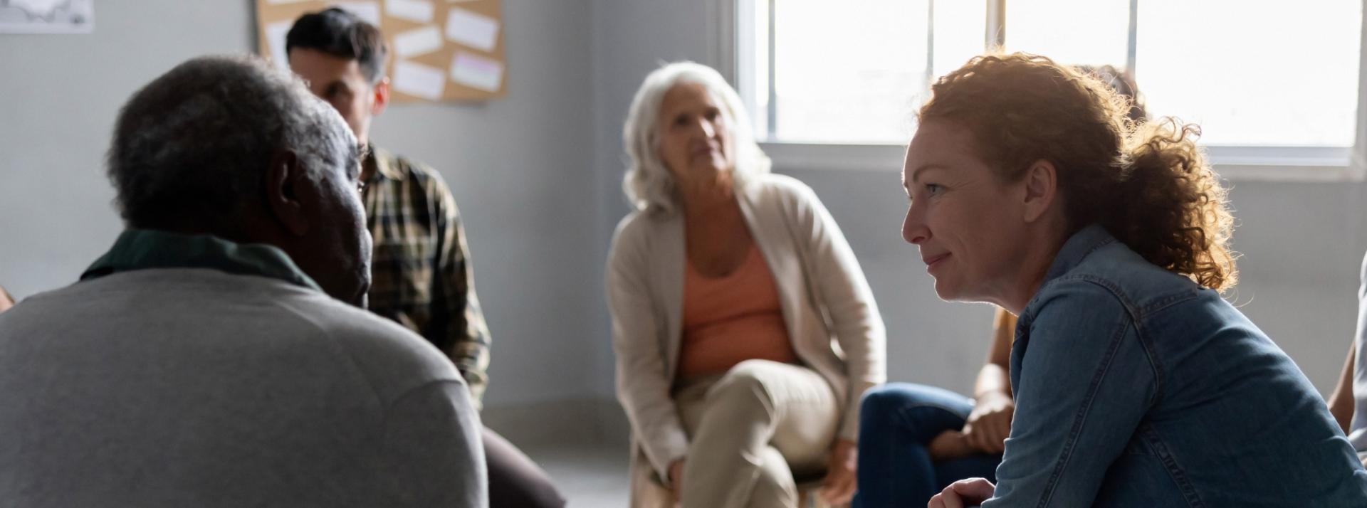 people sharing stories in a group therapy session