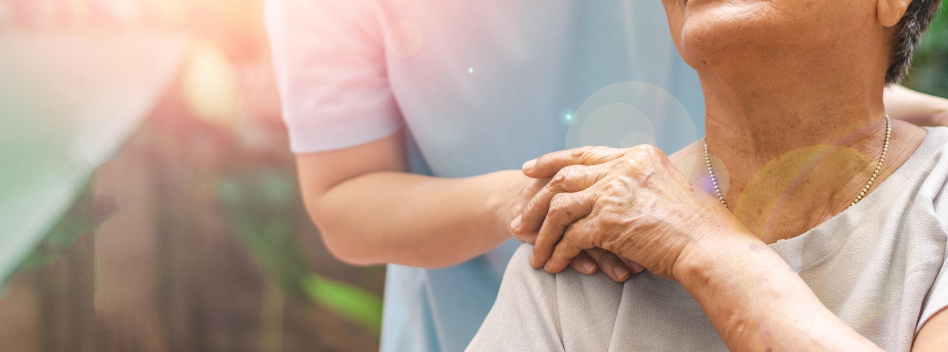 Caregiver, carer hand holding elder hand