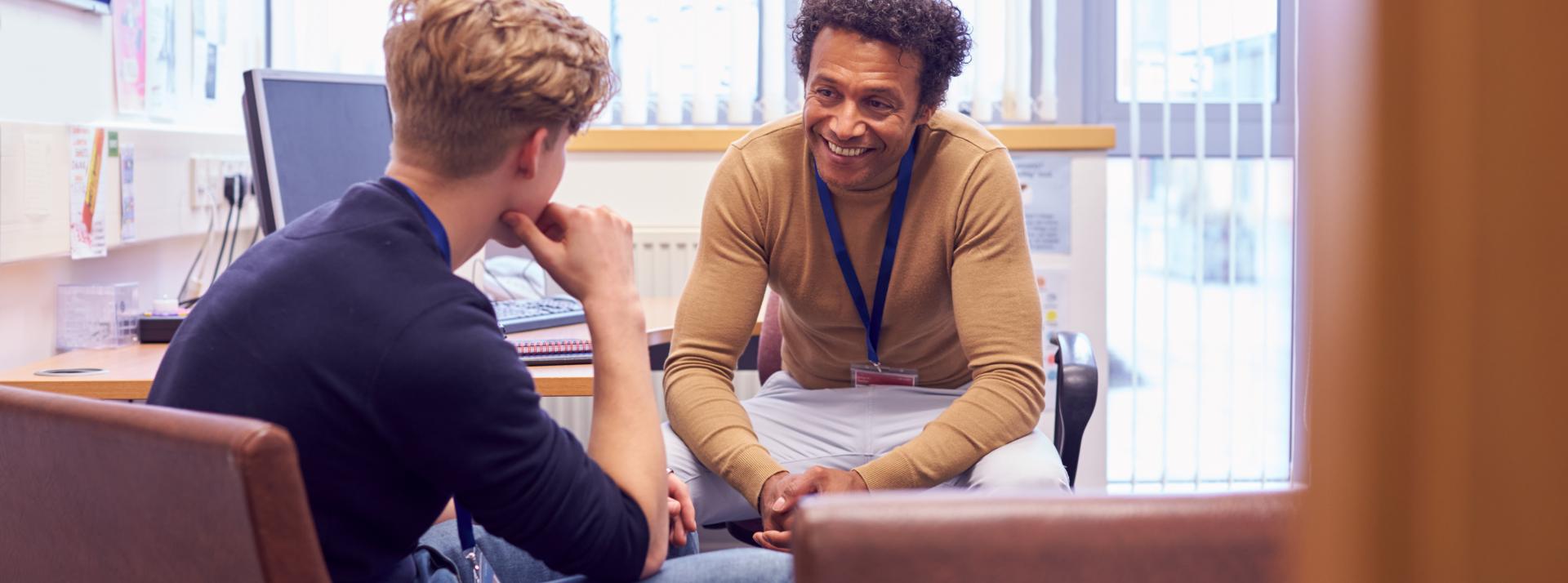 Two people having a conversation in an office.