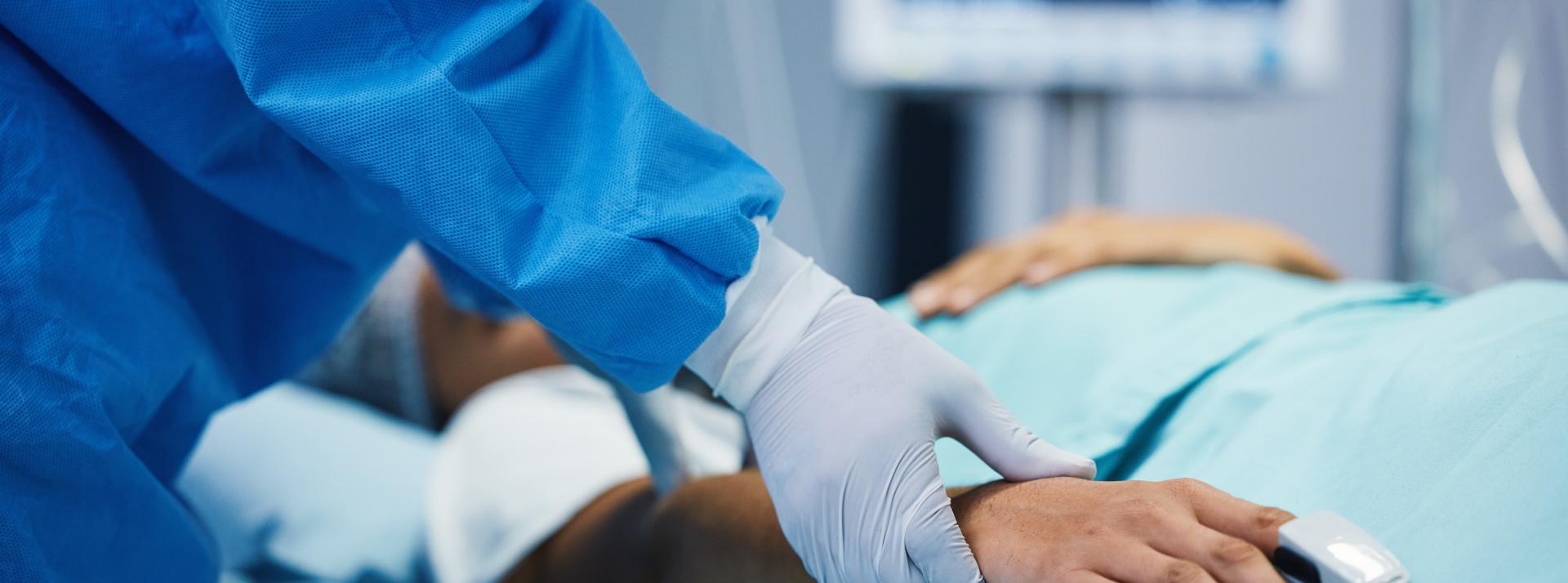 Physician holding patient's hand 