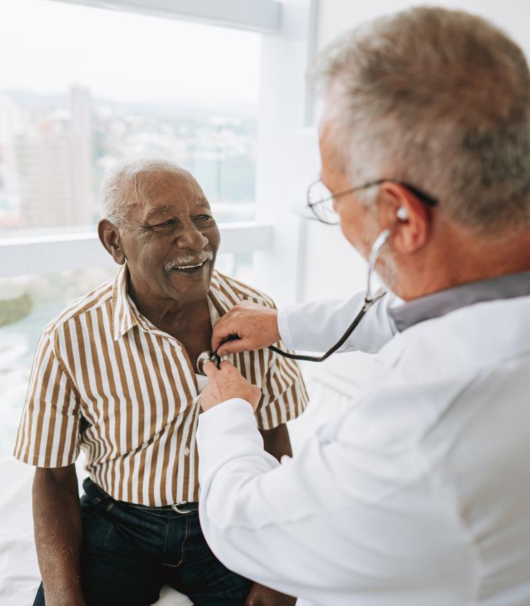 Portrait of a doctor listening to a patient's heartbeat