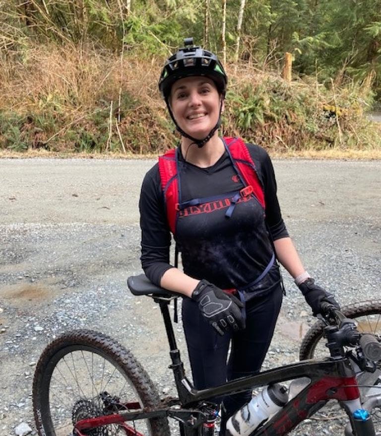 Kim Leahy smiling during a break on a mountain bike ride