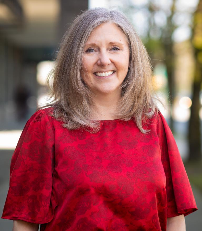 Bonnie Wilson from Vancouver Coastal Health standing and smiling.