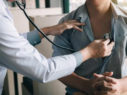 doctor using a stethoscope listen to the heartbeat of the elderly patient
