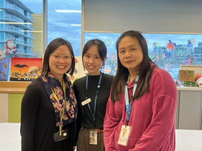 Team members stand in the activity room, the heart of the program's creative space.