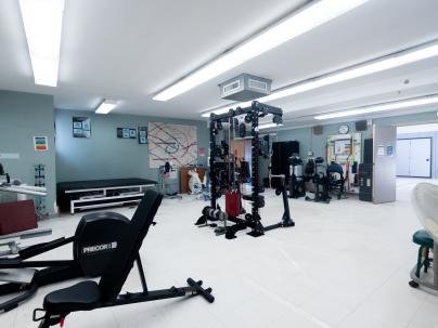 Adapted gym at G.F. Strong with various equipment around the room.