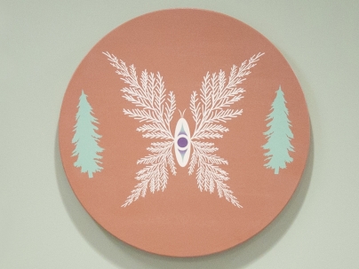 Indigenous artwork of a forest mounted on a white wall 