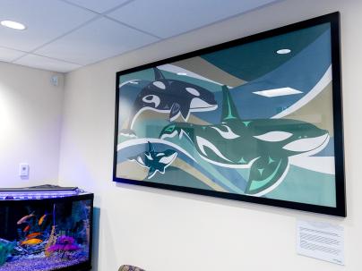 artwork on the wall in an office of three orca whales