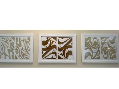 three framed abstract prints in a row on a wall