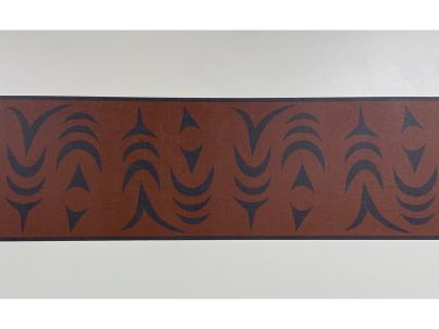 Indigenous artwork in an ochre colour of salmon mounted on a white wall 