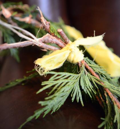 Closeup of ced boughs tied together laying on a desk.