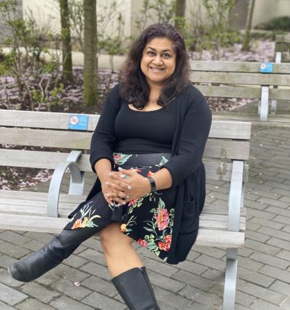 Farinah Kadir, RPN/Mental Health Nurse, sitting on a bench.