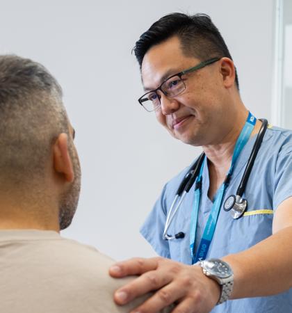 Physician has his hand on patient shoulder 