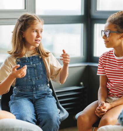 A group of children talking in a circle