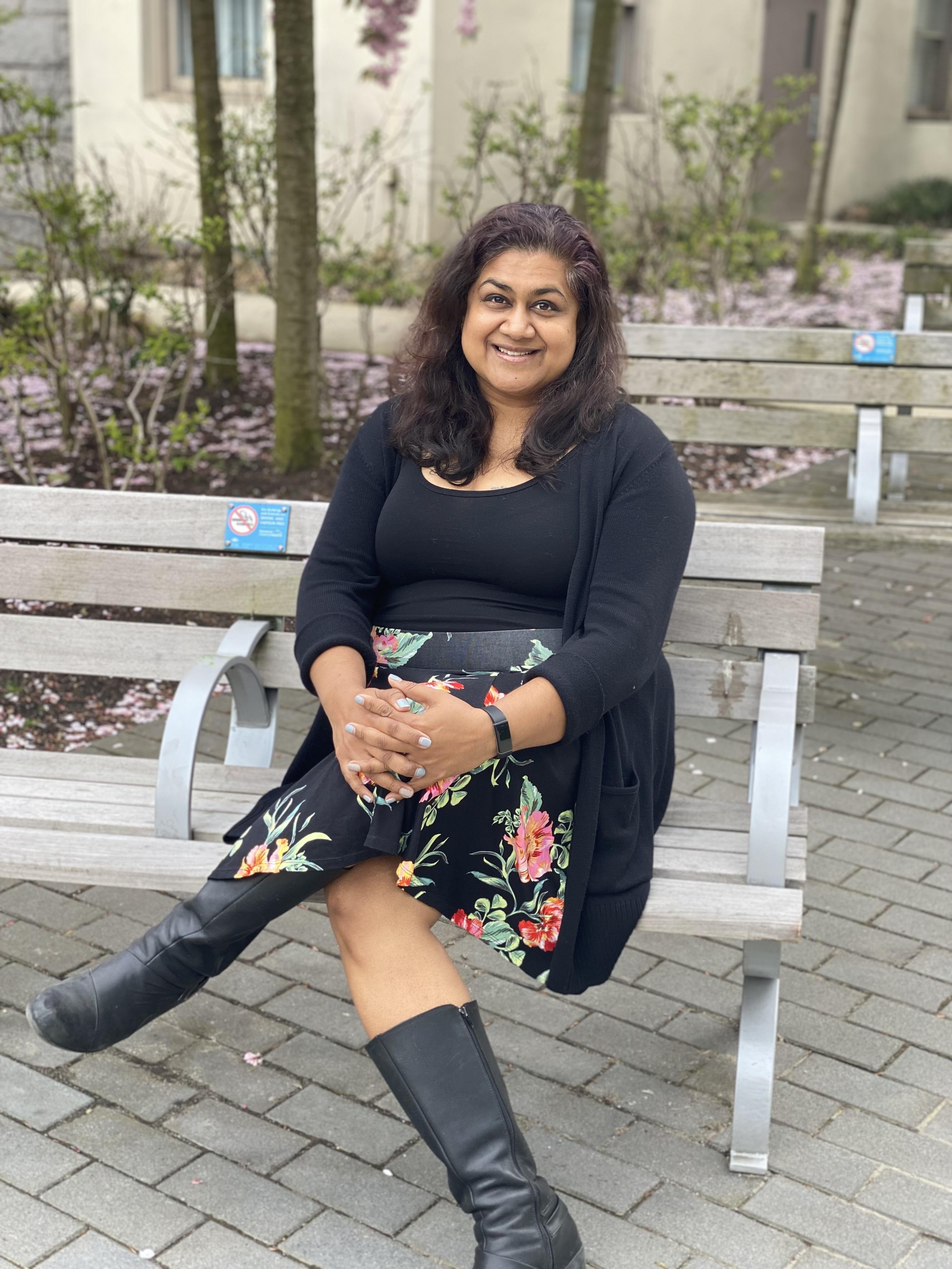 Farinah Kadir, RPN/Mental Health Nurse, sitting on a bench.